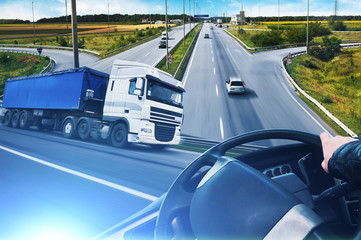 Abstract background with a truck, truck steering wheel and a road with cars and a sky with blue lights