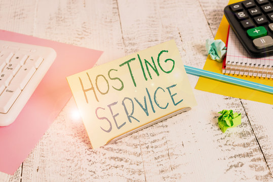 Conceptual hand writing showing Hosting Service. Concept meaning provides services for the website to be seen in the Internet Notepaper on buffer wire in between keyboard and math sheets