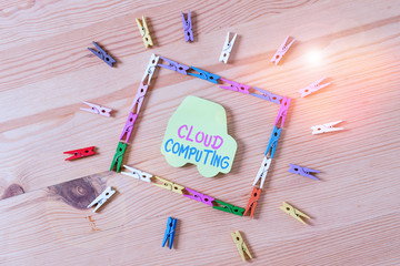 Text sign showing Cloud Computing. Business photo text storing and accessing data and programs over the Internet Colored clothespin papers empty reminder wooden floor background office
