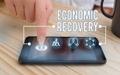Writing note showing Economic Recovery. Business concept for rise of business activity signaling...