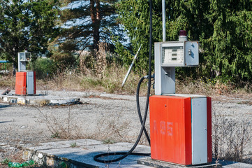 Old abandoned vintage obsolete petrol fuel gas dispenser in former petrol station