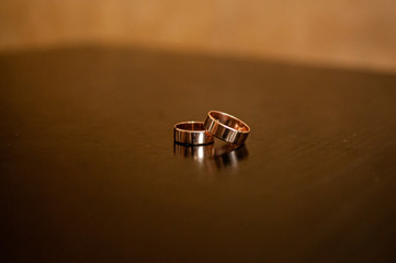 Pair of gold wedding rings on the table