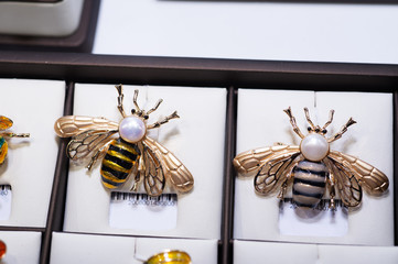 jewelry retail showcase display different bee brooches