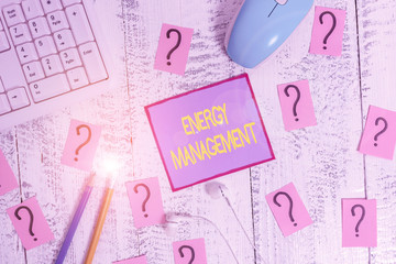 Handwriting text Energy Management. Conceptual photo way of tracking and monitoring energy to conserve usage Writing tools, computer stuff and scribbled paper on top of wooden table