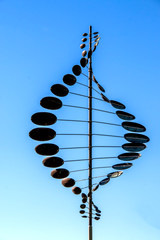 Twisting metal weathervane with circles - obrazy, fototapety, plakaty