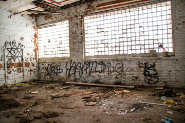 Abandoned run down building with graffiti and trash 