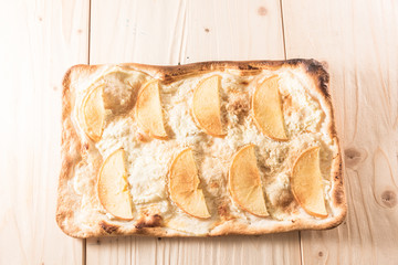 Crispy gold baked pizza slices on a wooden table.
