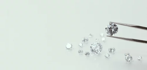 Zelfklevend Fotobehang brilliant cut diamond held by tweezers © Bugaev