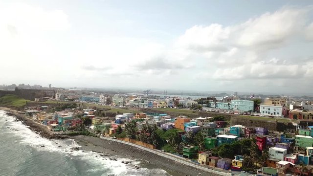 Cinematic Aerial of San Juan, Puerto Rico, La Perla Neighborhood and Waterfront and City Skyline