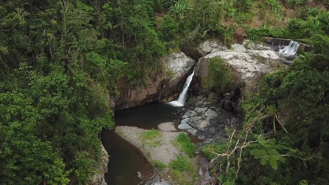 Las Garzas Waterfall, Adjuntas, Puerto Rico, Aerial View of Creek Water Falls in Pond Deep in Rainforest