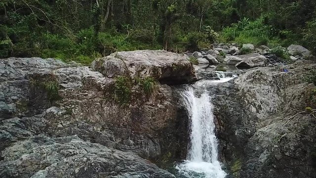 Slow Motion Aerial View of Las Garzas Waterfall, Charco El Ataud, Puerto Rico. Fresh Mountain Creek Water Falls into Natural Pool