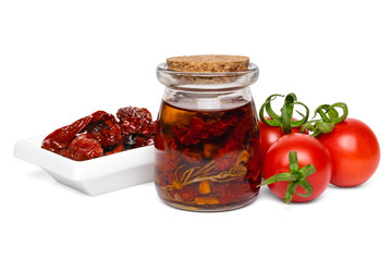 Homemade sun dried tomatoes in glass jar and fresh vegetables