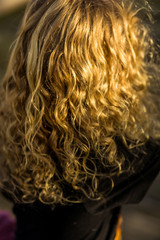 long curly hair in golden sunlight, no fce
