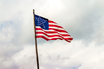 usa great star Flag waving in the wind in front of a cloudy sky with stars in the shape of a star