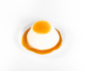 Italian dessert Panna cotta, creamy jelly with caramel sauce on a white background