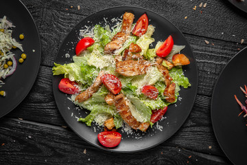 Salad with greens and grilled chicken. Tasty, juicy, nutritious. Quick and easy to cook. Octoberfest party dinner. Festive table with delicious food