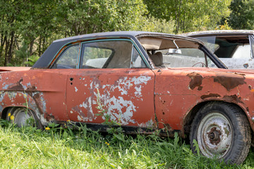 Old abandoned rusty vehicles, crushed cars in scrapyard, junk yard needed to be utilised and reused to protect nature and environment, metal recycling concept