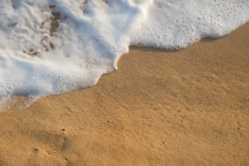 Tropical beach background with soft wave and white foam