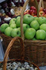 Green apples in a wicker basket.