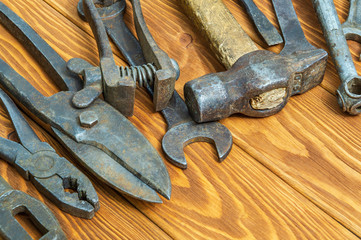 Old tools stacked after work on vintage wood background