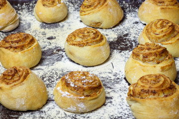 Homemade cakes, rolls with filling on a baking sheet.