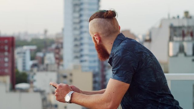 young man looking at the city from the rooftop