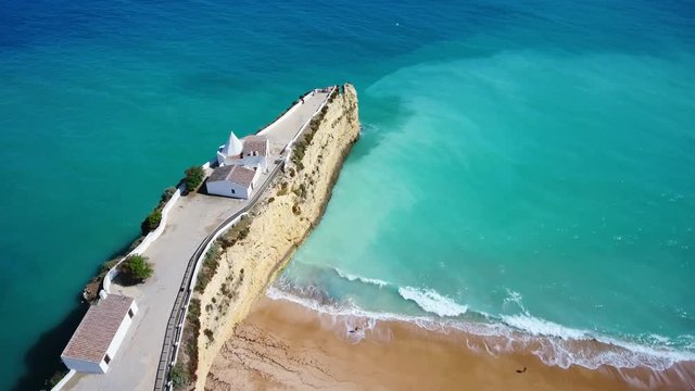 Aerial. Portuguese beach Senhora da Rocha, church on the cape, aerial view. Armacao de Pera Algarve