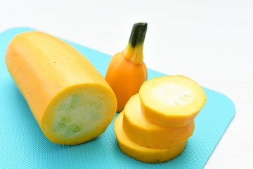 Fototapeta na wymiar Natural, whole and chopped yellow zucchini