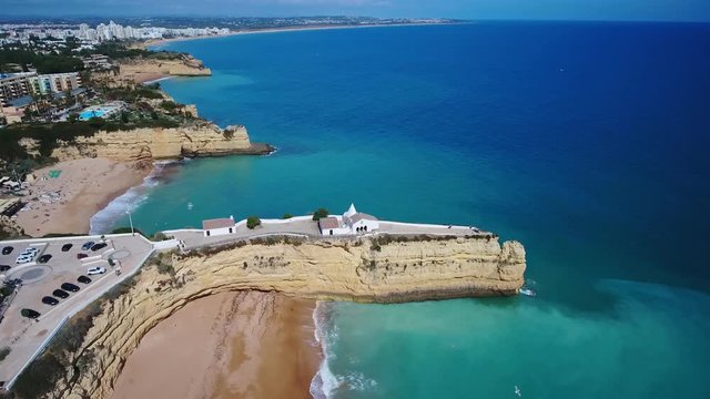 Aerial. Portuguese beach Senhora da Rocha, church on the cape, aerial view. Armacao de Pera Algarve