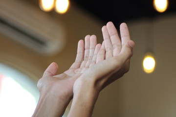 Raise a hand asking for prayer. The concept of praying in Islam by expecting blessings