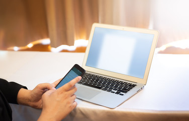 business man working on laptop and phone