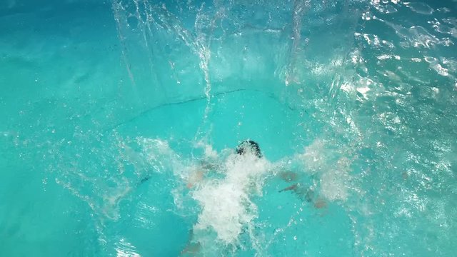 A child jumping into a holiday swimming pool