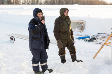 Fototapeta na wymiar Builders on the ice of a frozen river