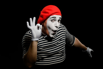 Man showing OK sign. Male mime artist making funny grimaces