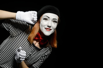 Pantomime actress leaning on wall. Portrait of smiling woman
