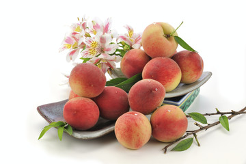 honey peach on the bowl with decoration at the white background