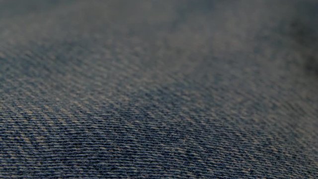 a blue jeans texture pattern closeup macro from sharp to blurry, shot in 4k 60p 10bit, ProRes422, with external atomos recorder.