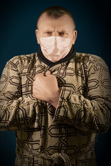 The man with a medical mask on a face. Protection against the infection which is transmitted in the...
