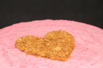 Valentine's Day Cake close-up, heart made of waffle chips on a pink mousse.
