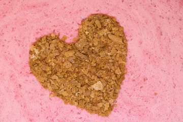 Valentine's Day Cake close-up, heart made of waffle chips on a pink mousse.