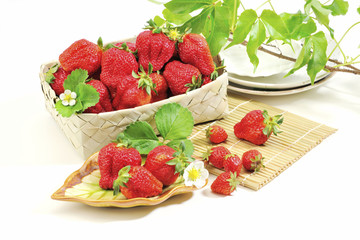 Strawberry white plate and basket at the white background