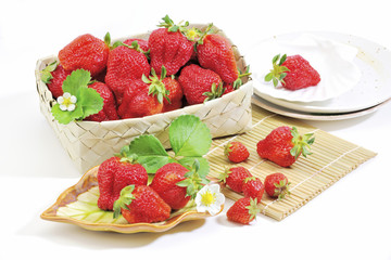 Strawberry white plate and basket at the white background