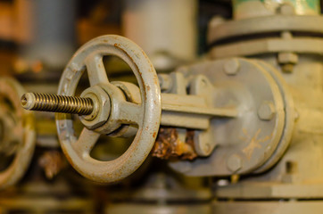 Round tap on the heating pipe. Rusty valve on the pipes.