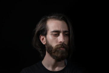 Hipster man solves a problem and thinks. Shot on black isolated background.