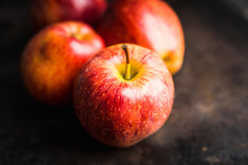 Close-up apples on the rustic wooden background. Selective focus. Shallow depth of field.