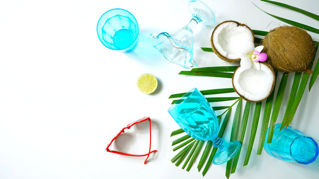 Coconut Summertime Entertaining Theme Flat Lay Creative Layout Overhead With Shadows From Blue Drinking Glasses Cast Over Table.