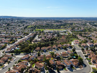 Aerial view of typical suburban neighborhood with big villas next to each other during sunny day, San Diego, California, USA. Aerial view of residential subdivision house