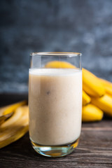 Banana milkshake with on the rustic background. Selective focus.