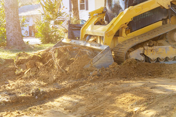 Close up of bulldozer scoop moving earth landscaping works