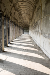 Obraz premium The traditional cement brick arch door with the shadow, it’s walkway along the cliff at the three gorge dam